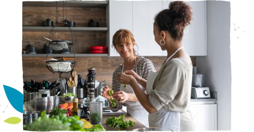 Dwie kobiety w kuchni robiące sałatkę.